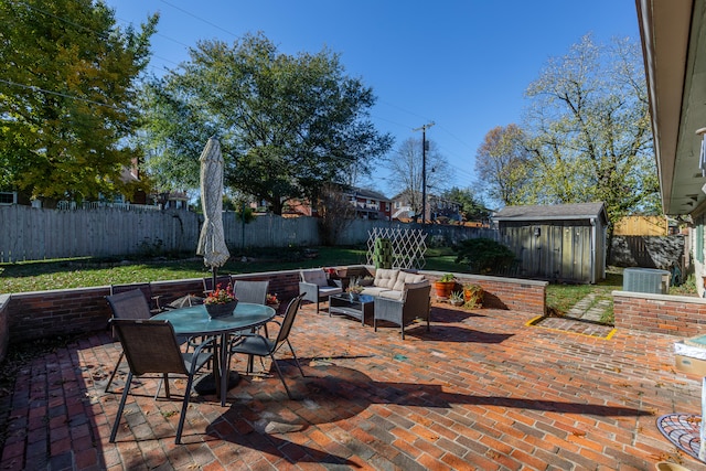 view of patio featuring a shed, central AC, and an outdoor hangout area