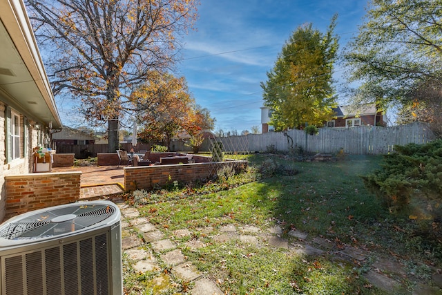 view of yard featuring central AC unit and a patio area