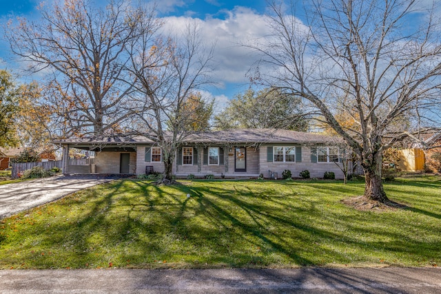 single story home featuring a carport and a front lawn