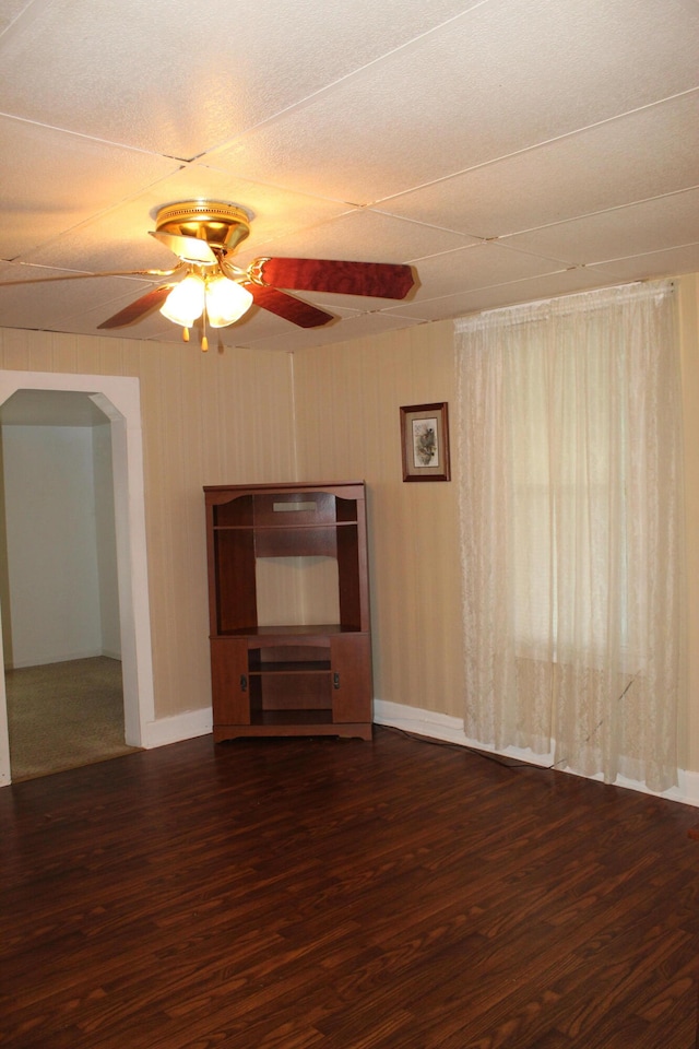 unfurnished living room featuring a textured ceiling, dark hardwood / wood-style floors, and ceiling fan