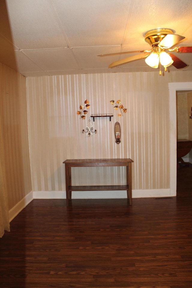 unfurnished room with ceiling fan and dark hardwood / wood-style floors