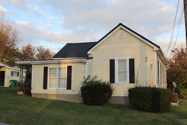 view of side of home featuring a yard