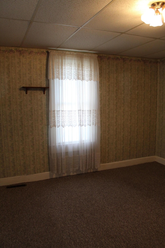 unfurnished room with a paneled ceiling