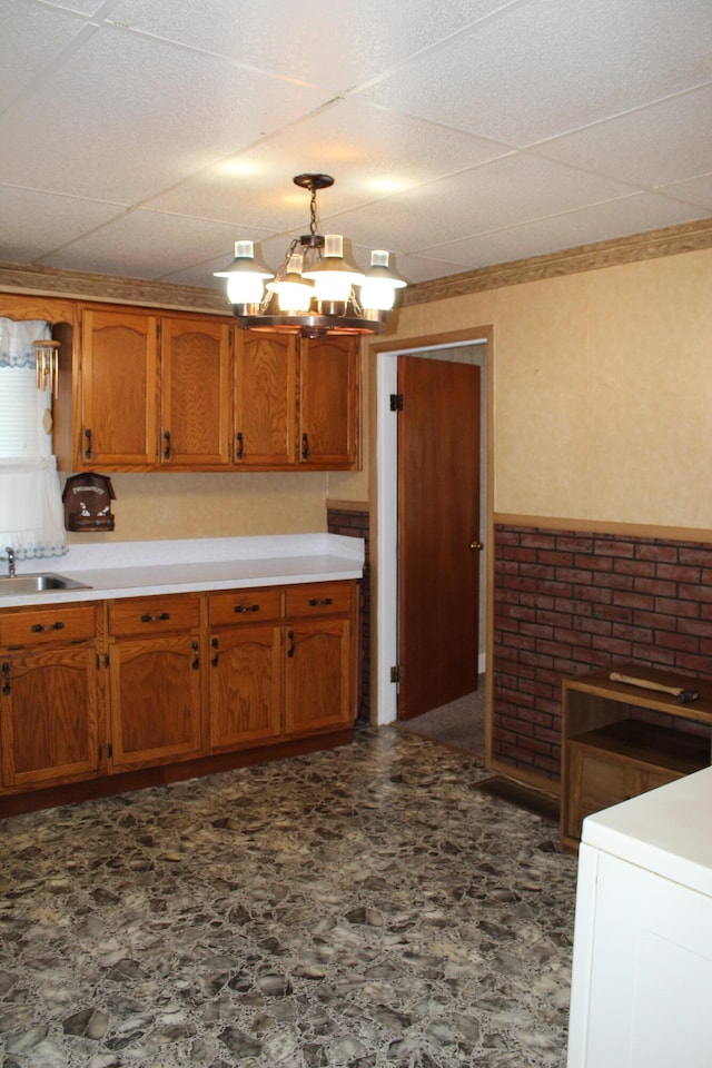 kitchen featuring a chandelier, sink, and pendant lighting