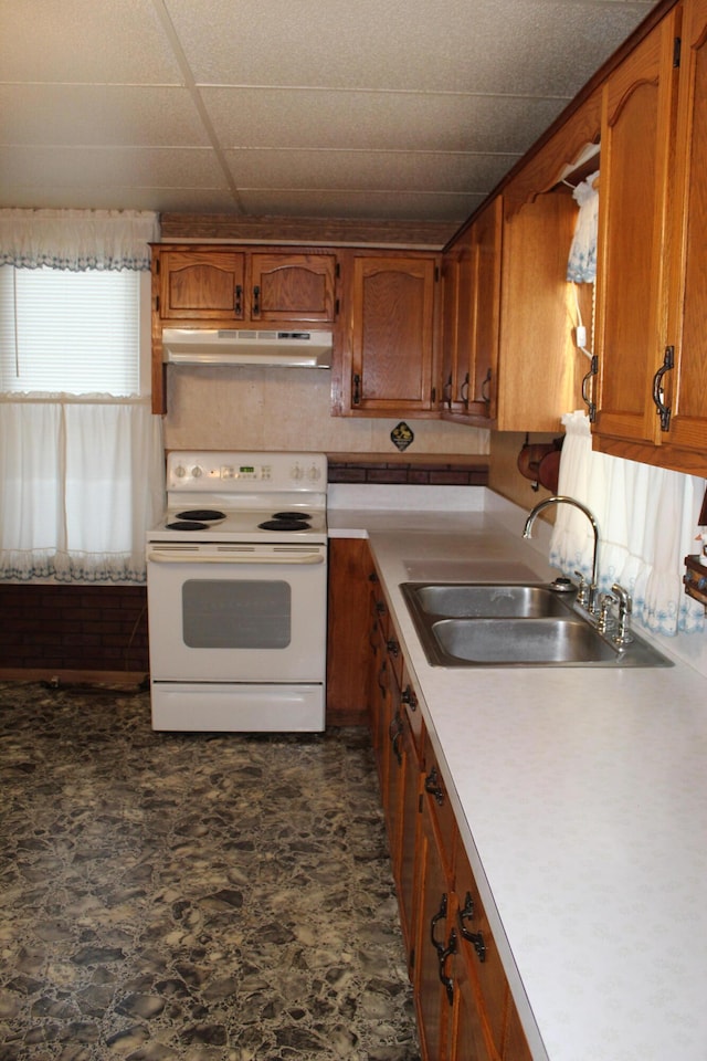 kitchen featuring a paneled ceiling, sink, and electric stove