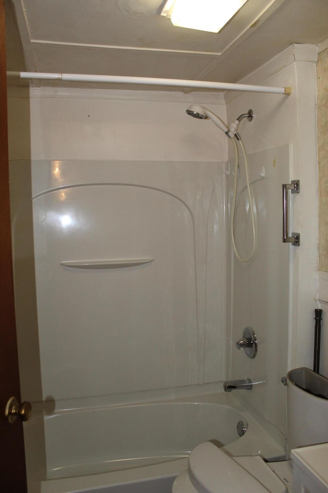 bathroom with shower / washtub combination and toilet