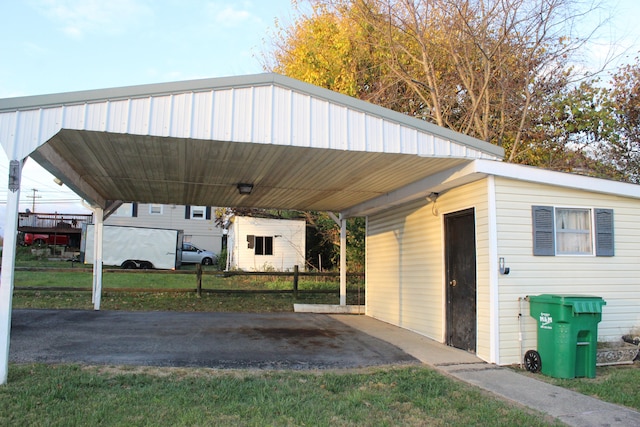 view of vehicle parking with a yard and a carport