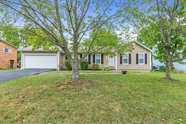 ranch-style house with a garage and a front lawn