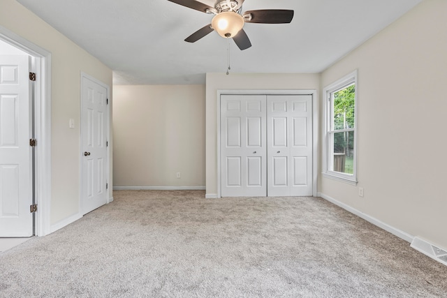 unfurnished bedroom featuring ceiling fan and light colored carpet