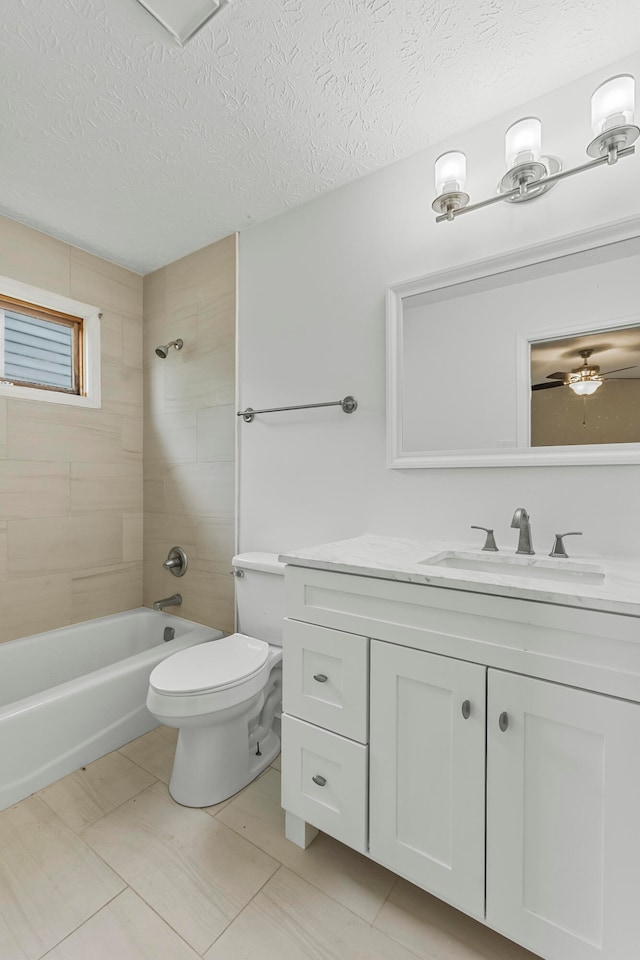 full bathroom featuring tile patterned floors, vanity, a textured ceiling, toilet, and tiled shower / bath