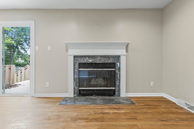 room details with a fireplace and wood-type flooring