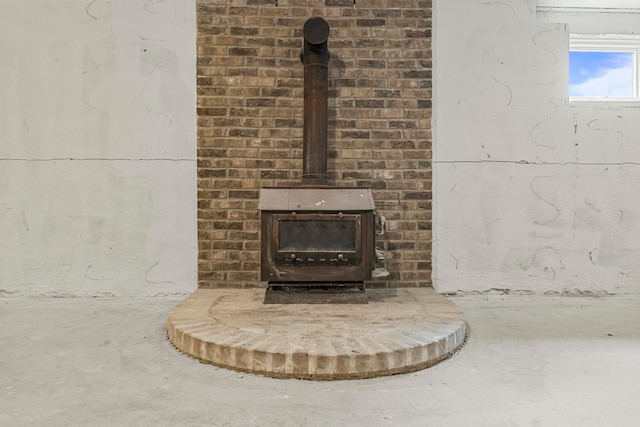 details with concrete floors and a wood stove