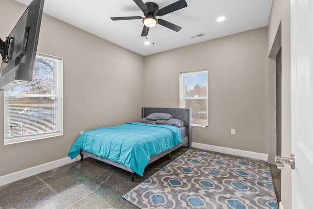 bedroom with multiple windows and ceiling fan