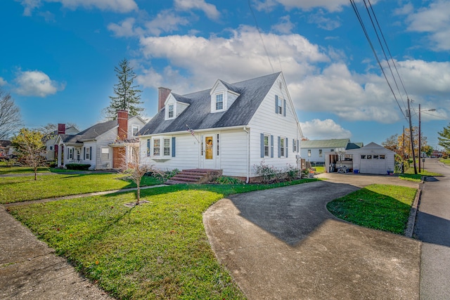 new england style home with a front lawn, a garage, and an outdoor structure