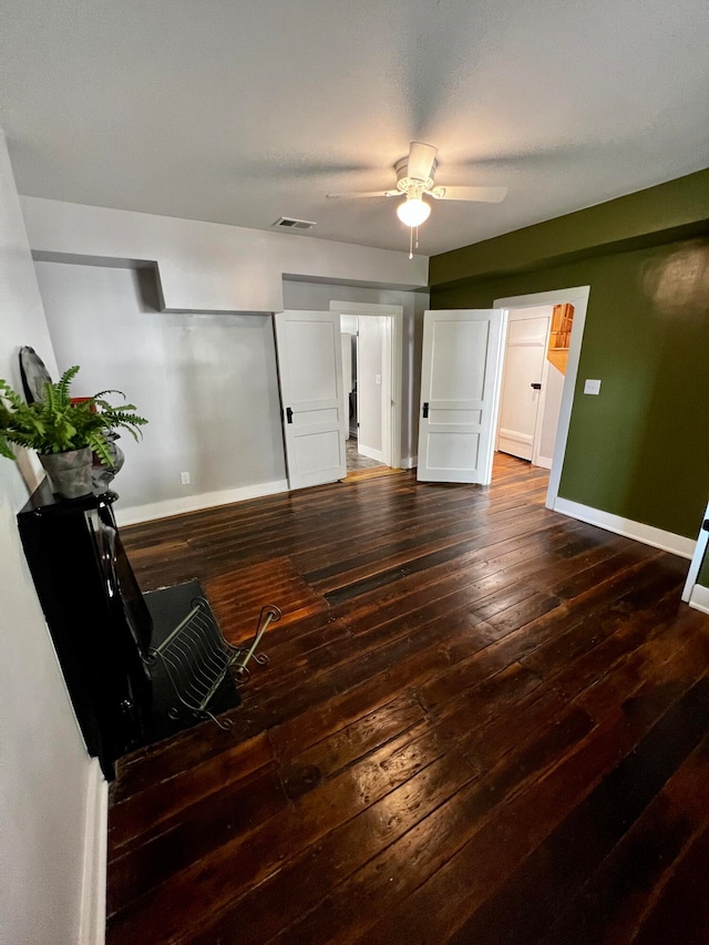 interior space with ceiling fan and dark hardwood / wood-style floors