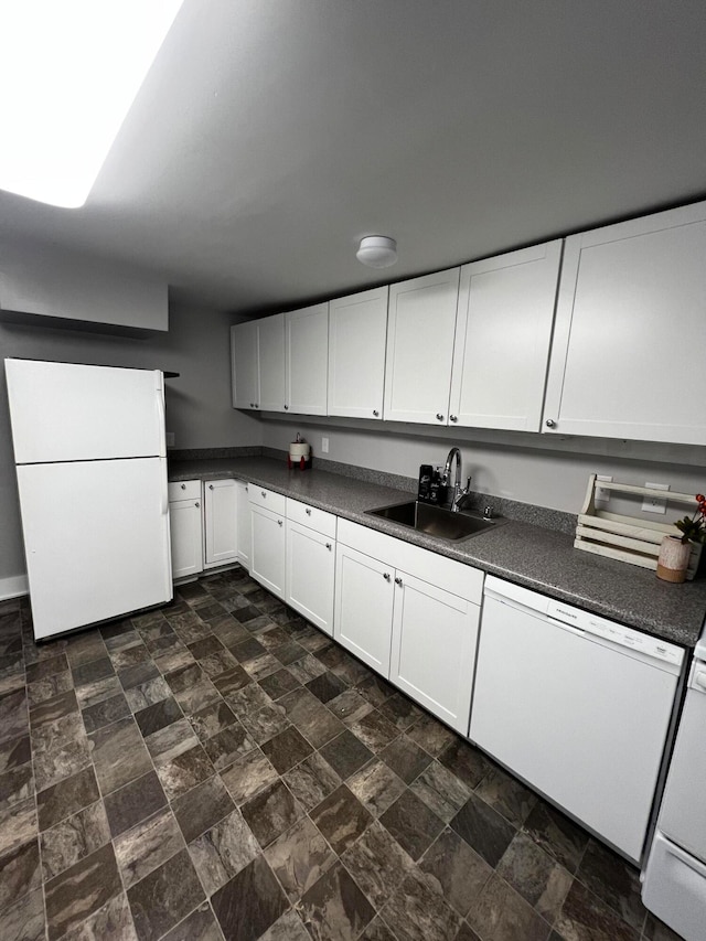 kitchen with white cabinets, sink, and white appliances