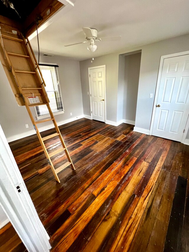 interior space featuring ceiling fan and dark hardwood / wood-style floors