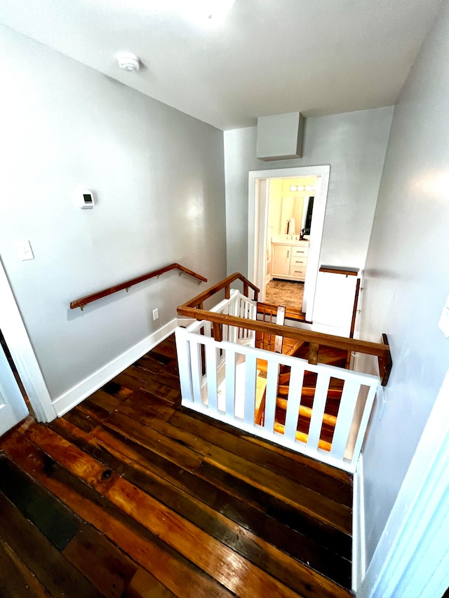 staircase with wood-type flooring