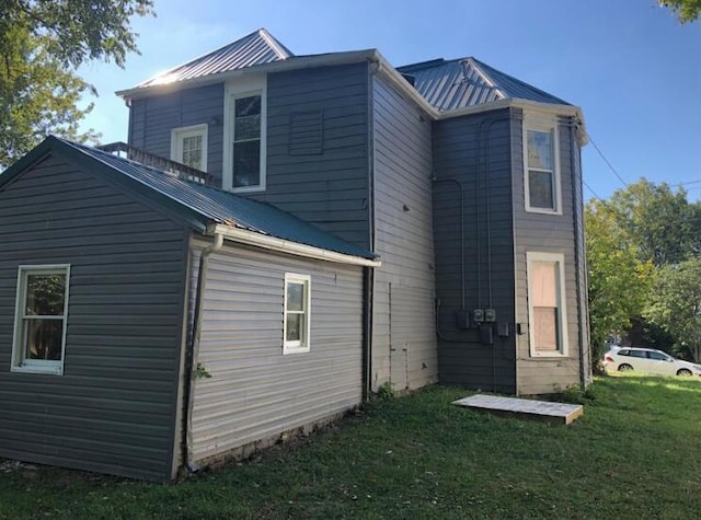 rear view of house with a lawn