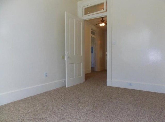 carpeted empty room with ceiling fan