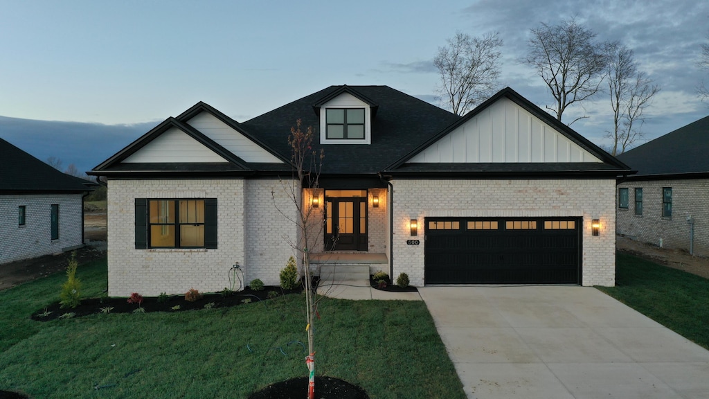 view of front of house with a garage and a yard