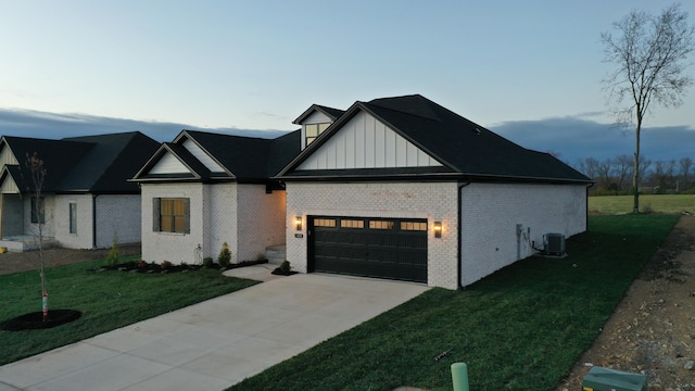 view of front of home with central AC and a yard