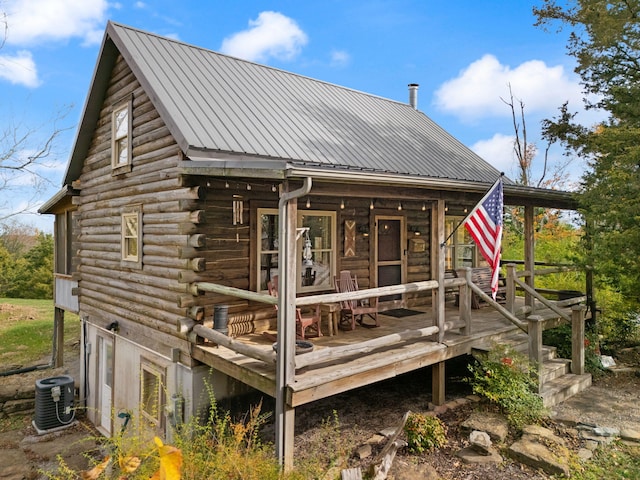 rear view of house with cooling unit and a deck