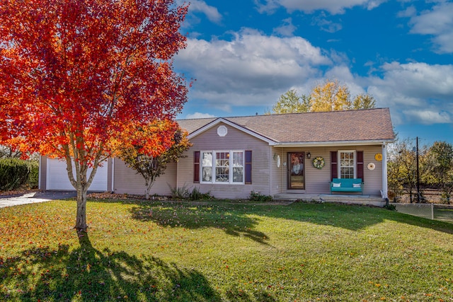 view of front of house featuring covered porch, a garage, and a front yard