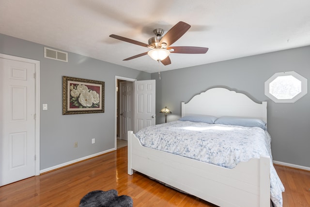 bedroom with hardwood / wood-style flooring and ceiling fan