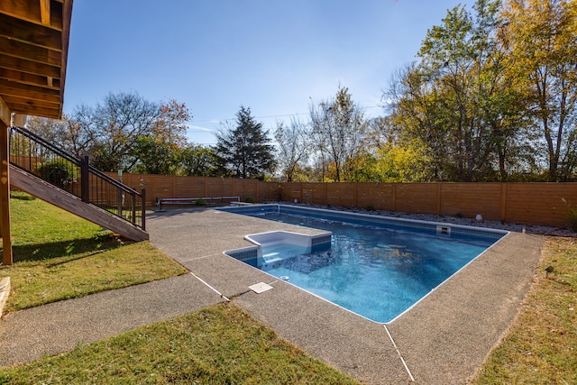 view of pool with a patio and a yard