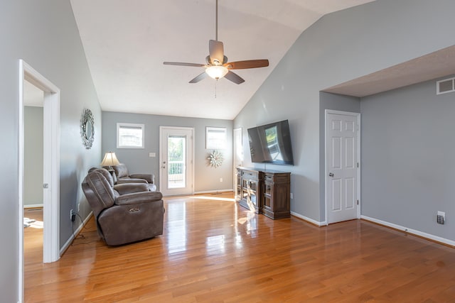 living room featuring light hardwood / wood-style floors, ceiling fan, and high vaulted ceiling