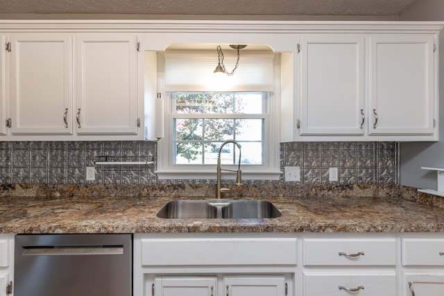 kitchen featuring white cabinetry, tasteful backsplash, stainless steel dishwasher, and sink