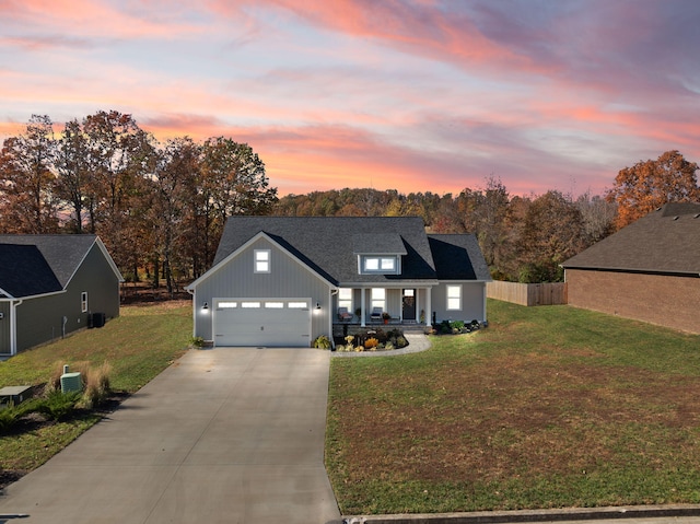 view of front of home featuring a garage and a yard