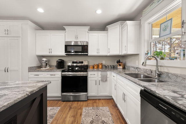 kitchen with white cabinetry, appliances with stainless steel finishes, and sink