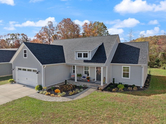 view of front facade with a garage, a porch, and a front lawn