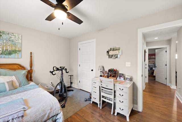 bedroom with dark wood-type flooring and ceiling fan