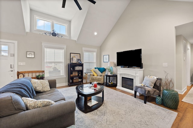 living room with high vaulted ceiling, wood-type flooring, and ceiling fan