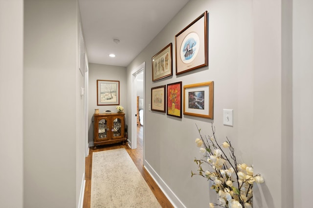 hallway with light hardwood / wood-style floors