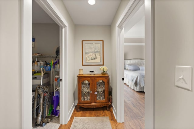 corridor with light hardwood / wood-style floors