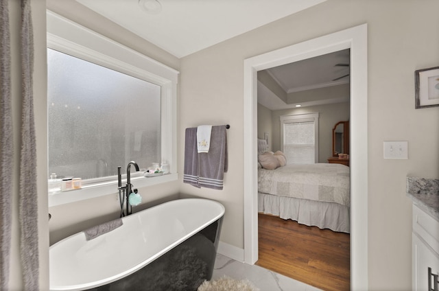 bathroom featuring vanity, hardwood / wood-style floors, and a bathing tub