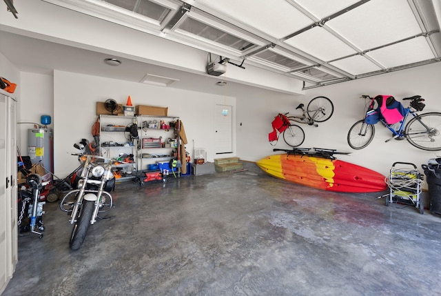 garage with water heater and a garage door opener