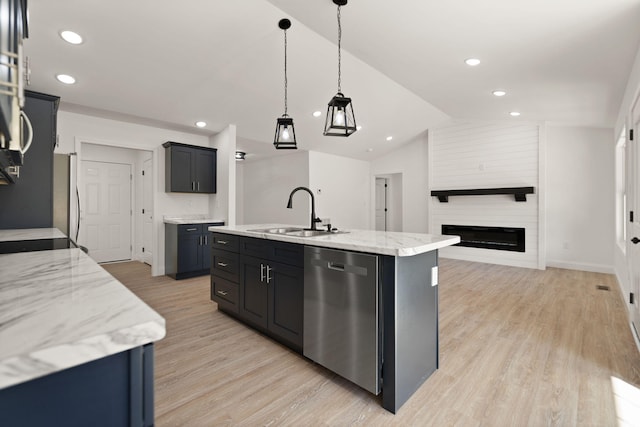 kitchen with a center island with sink, stainless steel appliances, sink, light hardwood / wood-style floors, and lofted ceiling