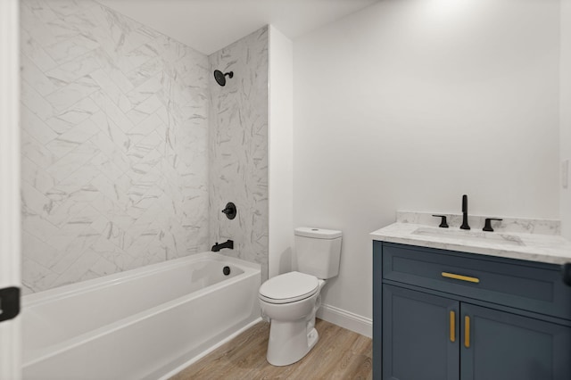 full bathroom featuring toilet, tiled shower / bath combo, vanity, and hardwood / wood-style flooring