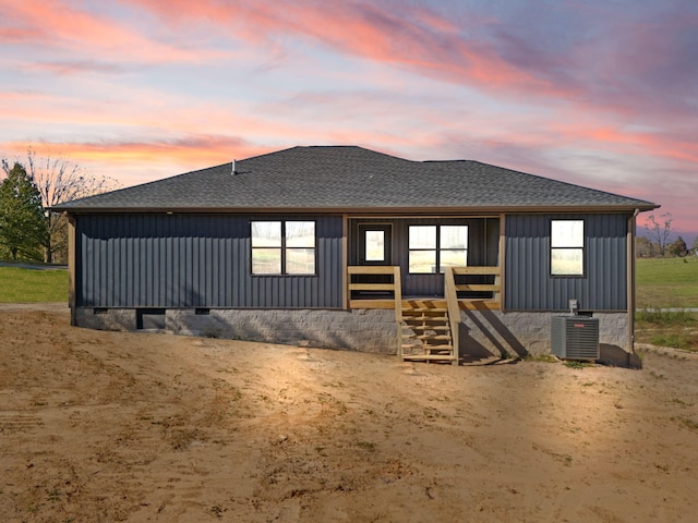 back house at dusk with central AC unit