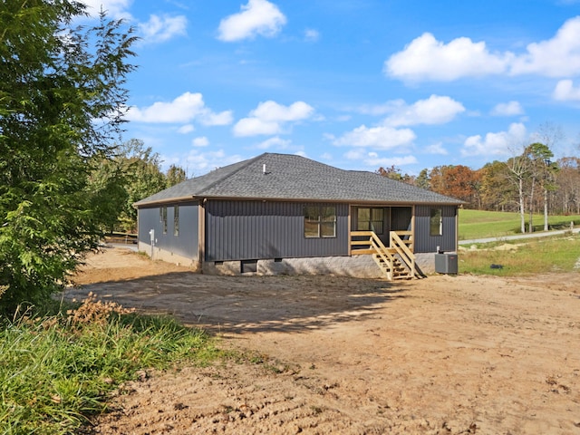 rear view of house featuring central AC unit