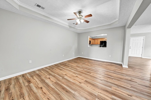 unfurnished living room featuring ornamental molding, ceiling fan, a textured ceiling, and light hardwood / wood-style floors