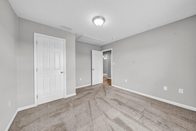 unfurnished bedroom featuring carpet and a textured ceiling