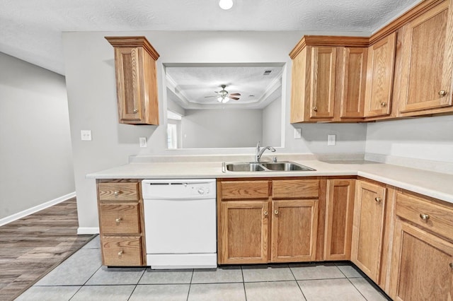 kitchen featuring white dishwasher, a textured ceiling, sink, ceiling fan, and light wood-type flooring