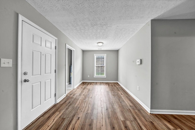 entryway featuring dark hardwood / wood-style flooring and a textured ceiling