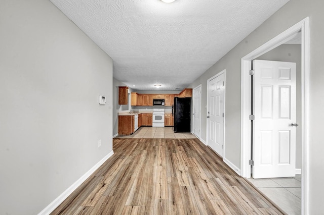 interior space featuring light hardwood / wood-style floors, a textured ceiling, and sink